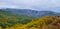 Autumn mountain valley under pale cloudy sky