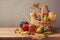 Autumn nature background. Fall fruits and pumpkin on wooden table. Thanksgiving table arrangement