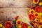 Autumn nature composition with orange and yellow gerbera flowers, decorative pumpkins, wheat ears on table top view. Thanksgiving