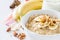 Autumn oatmeal in white bowl banana honey