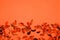 autumn orange background with potpourri on the lower part and copy space on the upper part, flat lay