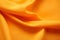 Autumn orange colour satin cloth folds abstract background