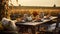 Autumn outdoor dinner table in a field, with a reclaimed barn wood table and hay bale seating