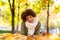 Autumn outdoor portrait of beautiful African American young woman lying down - Black people