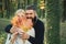 Autumn outdoor portrait of beautiful happy girl and bearded man walking in park or forest. Fashion autumn portrait woman