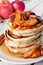 Autumn pancake stack with baked apples, pecans and cinnamon