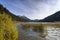 autumn panorama from the lake haldensee in tannheimertal with reeds and bushes