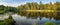 Autumn panorama with a pond and pines on the shore, Russia Ural