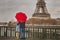 Autumn in Paris, couple under red umbrella near Eiffel tower, fall season, love in rainy day
