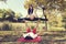 Autumn Park Couple doing acro yoga. Pregnancy