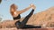 The autumn park creates the perfect aura for practicing yoga and relaxing outdoors. The woman concentrates on practicing