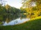 Autumn park landscape with people boating in a lake