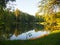 Autumn park landscape with people boating in a lake