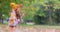 Autumn park and young girl playing with fallen leaves