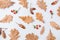Autumn pattern composition. Acorns, golden aok leaves and red berries on white background. Autumn pattern design element. Flat lay