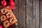 Autumn peanut butter apple rounds. Top view side border on a rustic wood background.