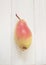 Autumn pear on white wooden board