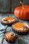 Autumn pies. Vegetarian pumpkin tartlets with nuts and oats on s