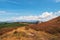 Autumn plateau. Hiking up the mountain trail. A bright atmospher