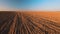 Autumn Plowed Field In Sunset Light. Ploughed Field. Farmland Agricultural Landscape. Rows Patterns Background
