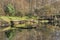 Autumn pond with a platform for anglers