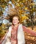 Autumn portrait of adorable smiling little girl child preteen having fun in the park