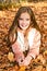Autumn portrait of adorable smiling little girl child preteen having fun in the park