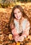 Autumn portrait of adorable smiling little girl child preteen in the park