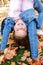 Autumn portrait of adorable smiling little girl child standing upside down on grass