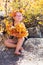 Autumn portrait baby holding yellow Leaves