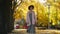 autumn portrait of beautiful smiling woman wearing in dress, sweater and hat. girl on yellow leaves background looking