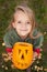 Autumn portrait with a Halloween pumpkin jack-o-lantern