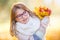 Autumn. Portrait of a smiling young girl who is holding in her hand a bouquet of autumn maple leaves.