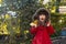 Autumn portrait of surprised curly girl. Kid gathering yellow fall foliage.