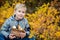 Autumn Portrait Toddler boy in leaves