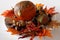 Autumn products on the wooden plate. Background with pumpkin, chestnuts, peppers and fall leaves