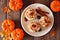Autumn pumpkin spice pecan cupcakes with creamy frosting, top view table scene over wood