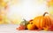 Autumn pumpkins background with copy space, blurred bokeh lights. Maple leaves, Wooden table. Halloween concept.