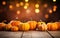 Autumn pumpkins background with copy space, blurred bokeh lights. Wooden table. Halloween concept. Thanksgiving day