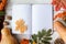 Autumn pumpkins, dried leaves, notebook, plaid on white wood background. Autumn, fall, halloween concept. Flat lay