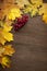 Autumn red and orange leaf and berry on old wood background. Top view autumn backdrop