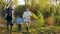 Autumn rest, cute boy together with grandparents walks in forest on good weather on weekend