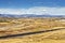 Autumn rural landscape with cargo train and Rocky Mountains.