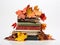 Autumn\'s Chapters: Stack of Worn-Out Books Marked with Vibrant Fall Leaves on a Pure White Canvas