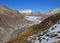 Autumn scene in Switzerland. Golden larch forest, Aletsch glacier and mountains.