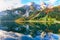 autumn scenery with Dachstein mountain summit reflecting in crystal clear Gosausee mountain lake