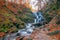 Autumn scenery with famous waterfall Shypit near Volovetz in Carpathian mountains, Ukraine