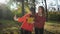 Autumn season, beautiful smiling young women friends taking selfie on cell phone with bouquet of yellow leaves in