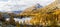 Autumn season with golden larch trees over Lake Viola