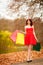 Autumn shopper woman with sale bags outdoor in park